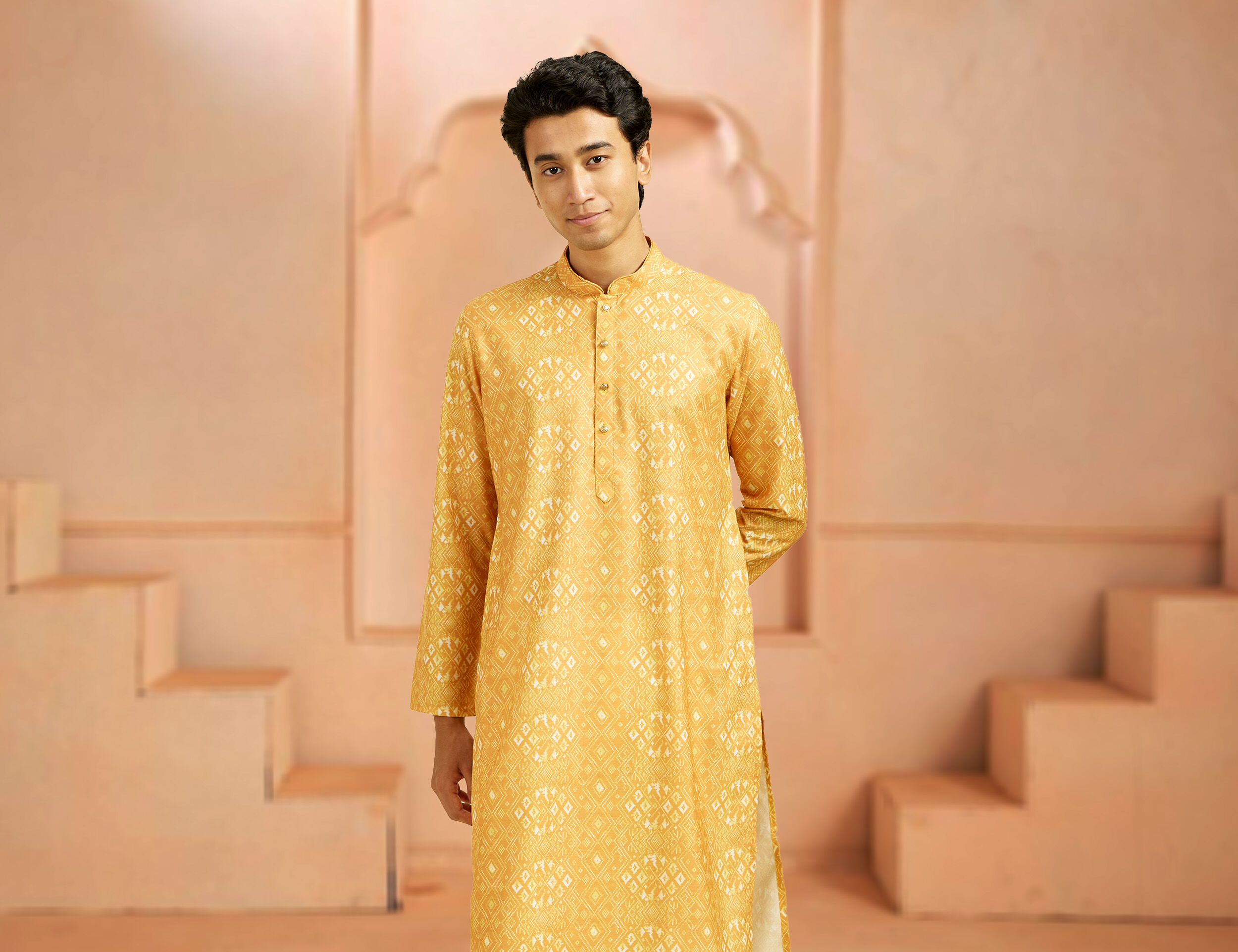 A boy wearing yellow kurta for holi festival